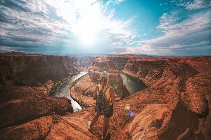 Woman standing on top of canyon Woman standing on top of canyon